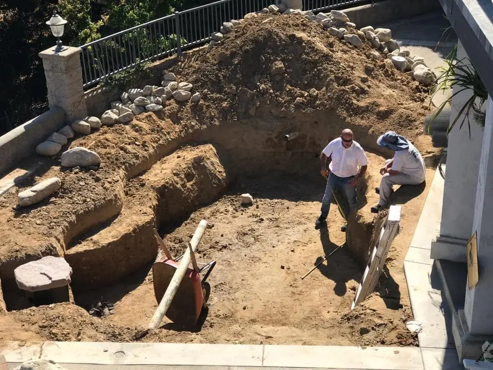 The Pond Pros crew excavating a backyard for a new koi pond